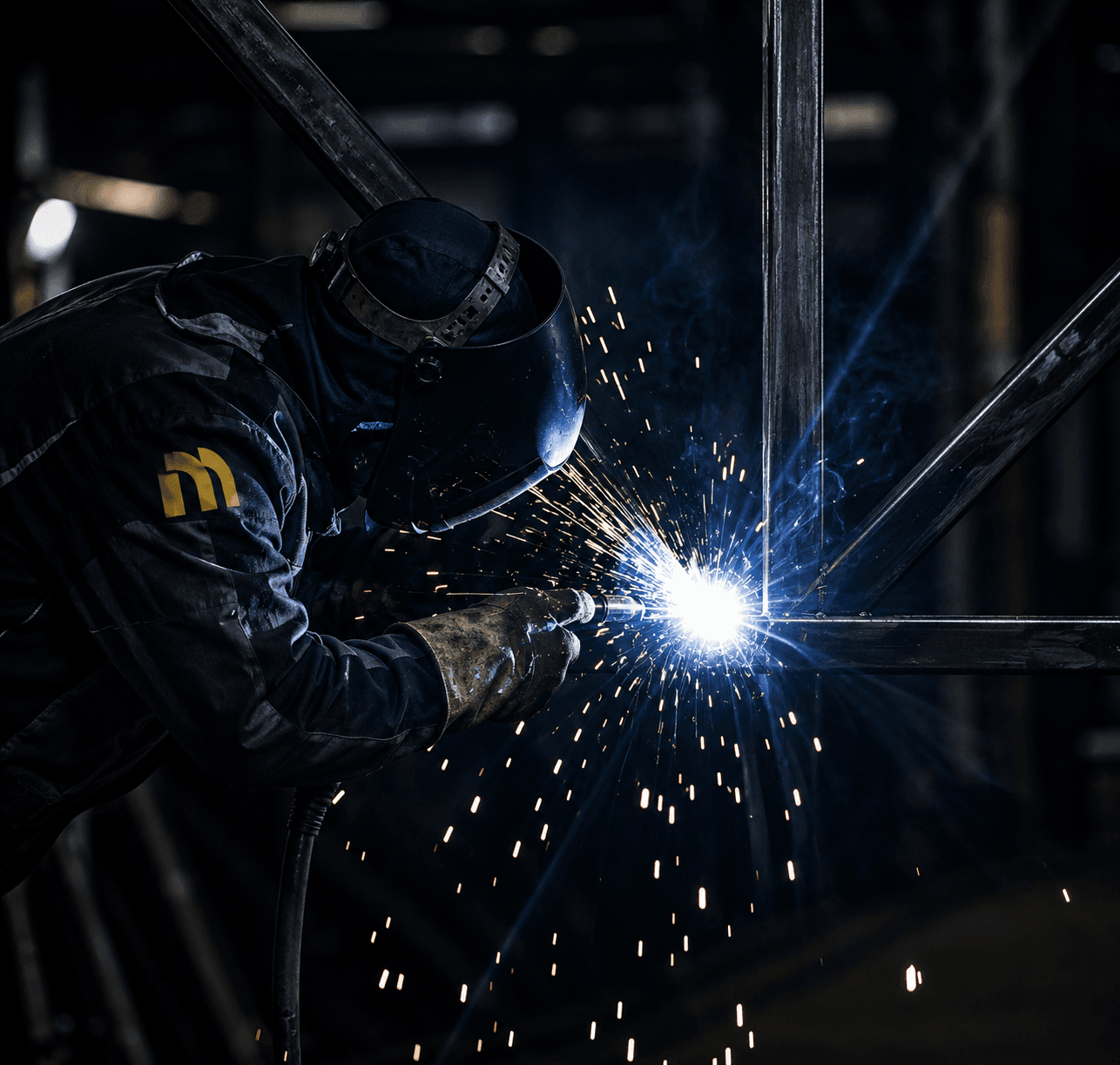 Welder fabricating a steel structure in the Metalex workshop