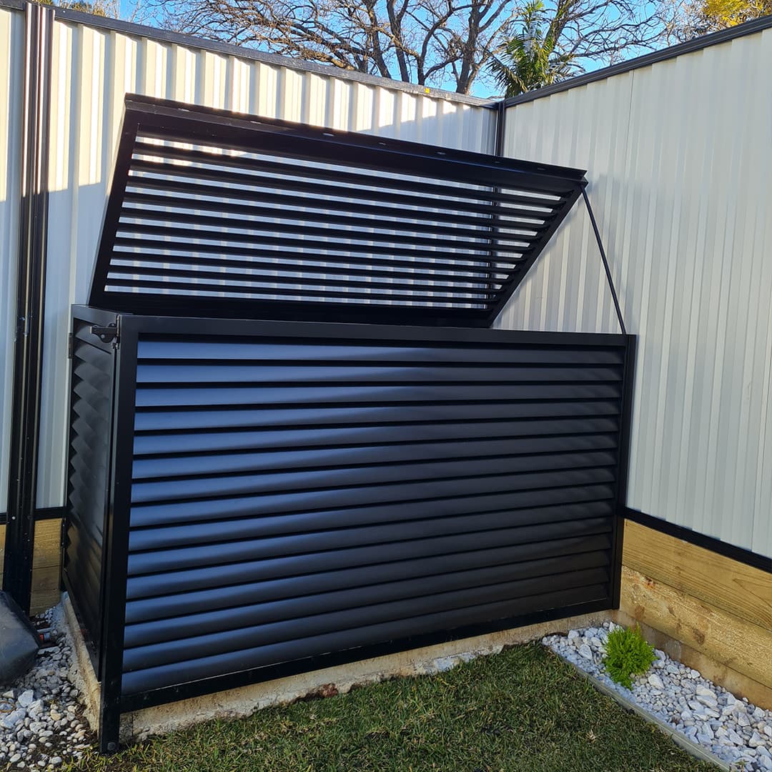 Custom black louvered metal enclosure with an open lid, fabricated for outdoor equipment
