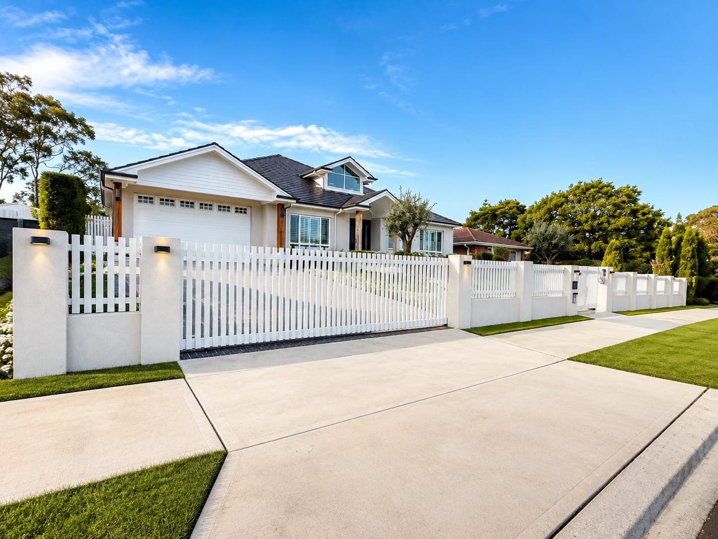 White aluminium slat fence and driveway gate on a contemporary Sydney home